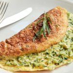 Omelette with zucchini in a frying pan. Dietary recipe with photo 