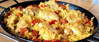 Paella with chicken. Classic recipe with mushrooms, seafood, vegetables, shrimp, squid 