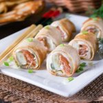 Pancake rolls for the festive table with salmon, cheese, crab sticks